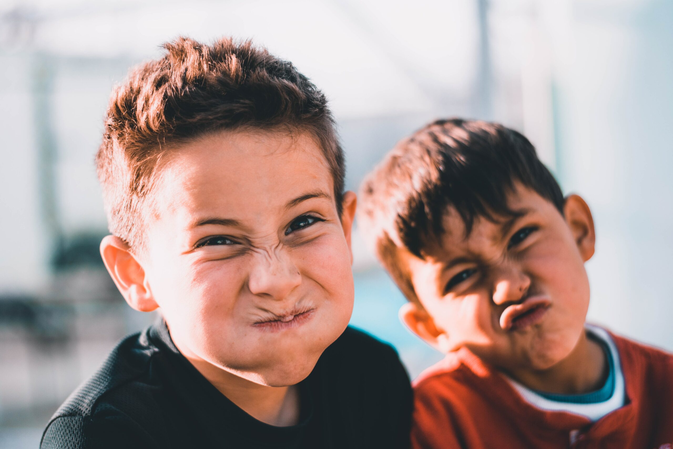 two young boys making faces