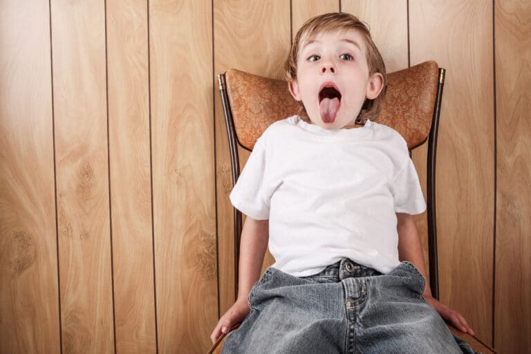 boy sitting on the naughty step chair - should parents use Time Out?