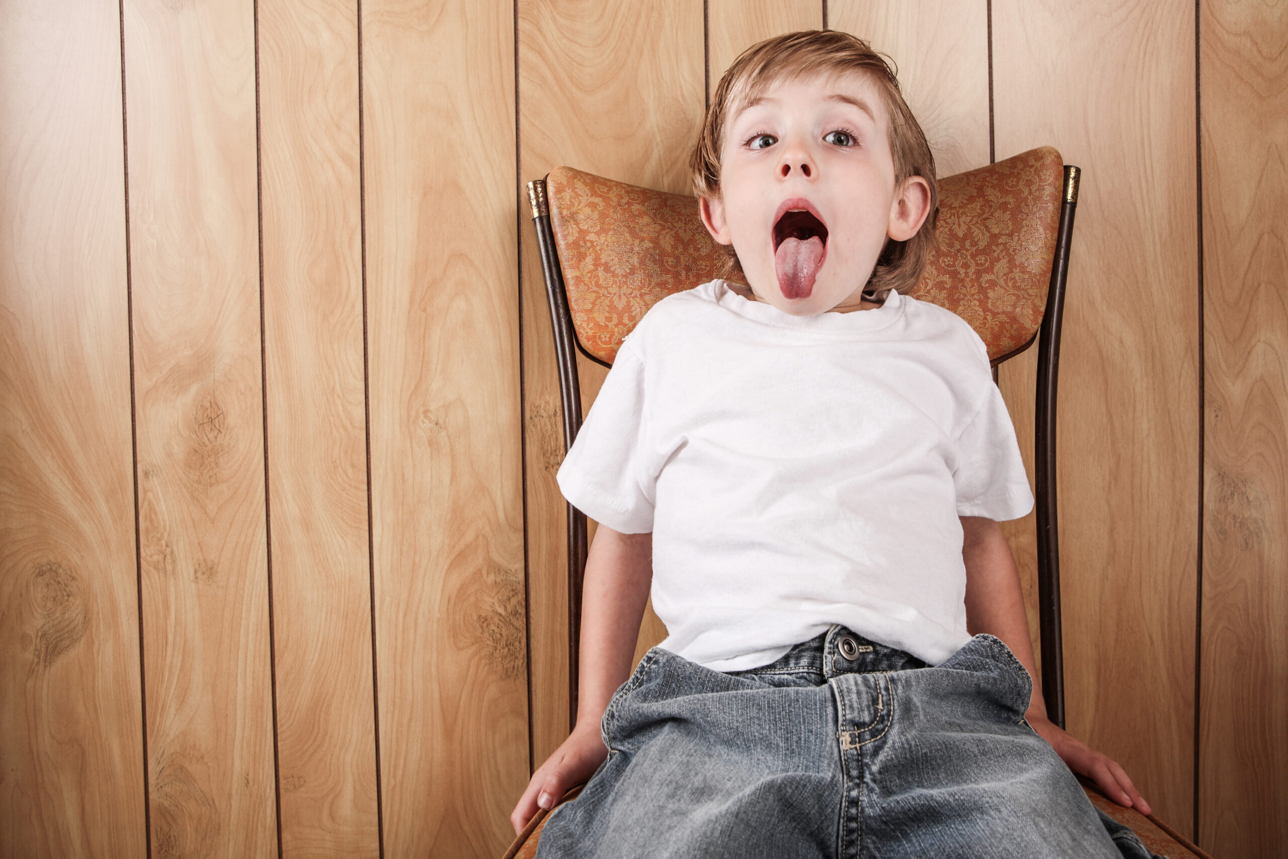 boy sitting on the naughty step chair - should parents use Time Out?