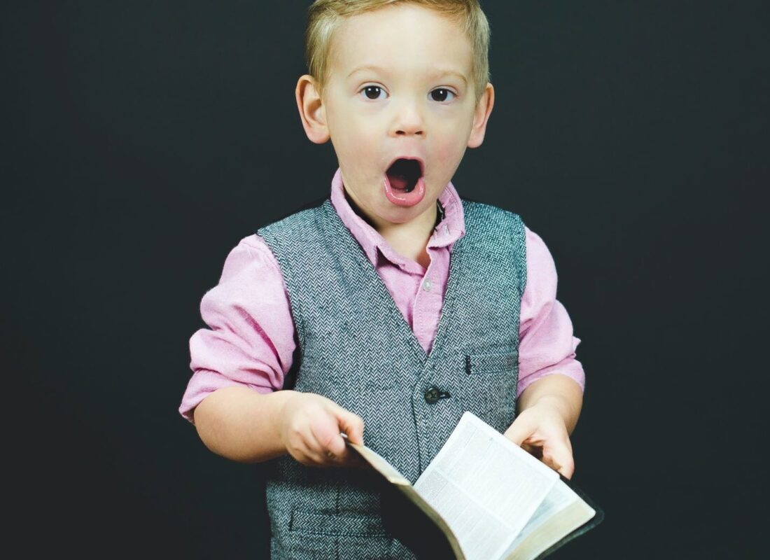 photo of young boy reading book, children's books on lying article