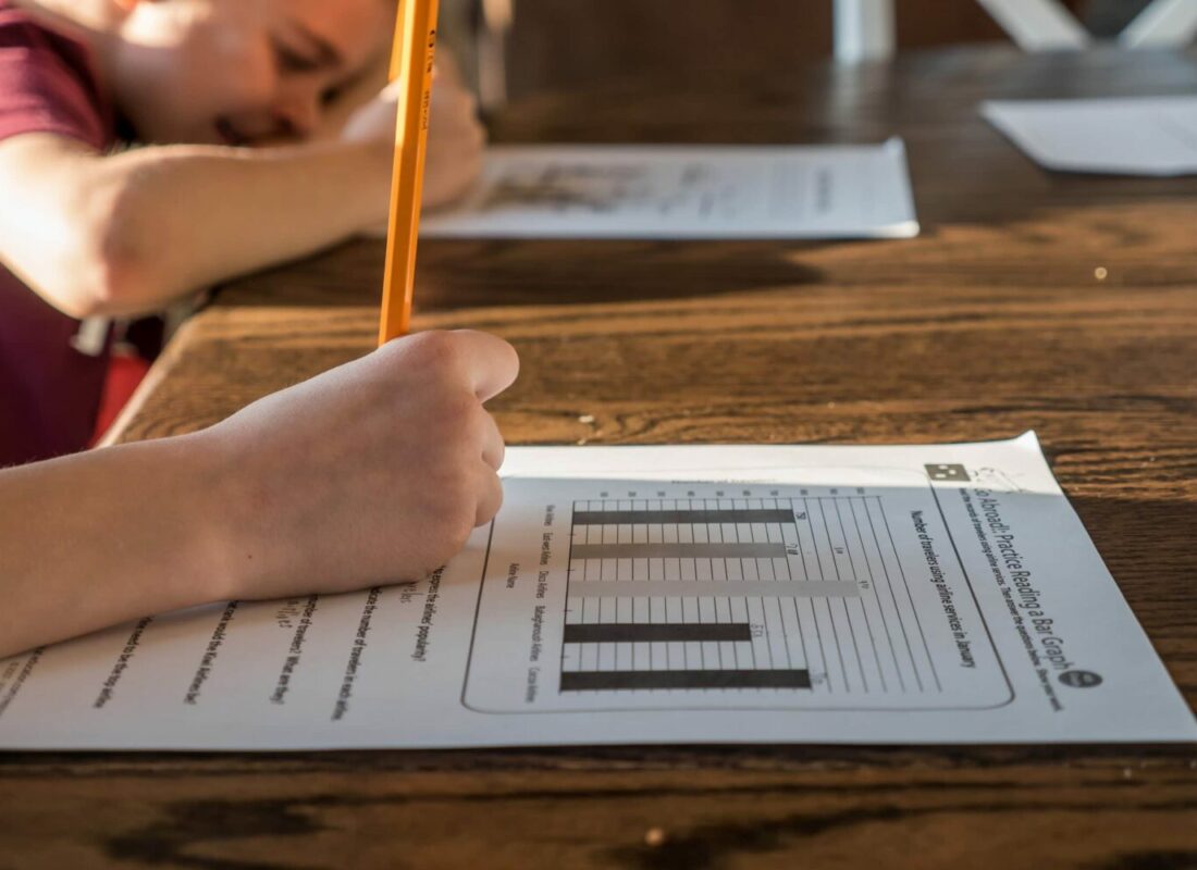 Photo of child doing homework, advice on How to make homework a happy habit by parenting expert Anita Cleare, photo of child writing