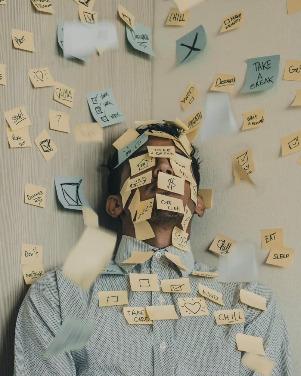 Photo of man covered in Post-Its to illustrate article on balancing work and parenting when working from home
