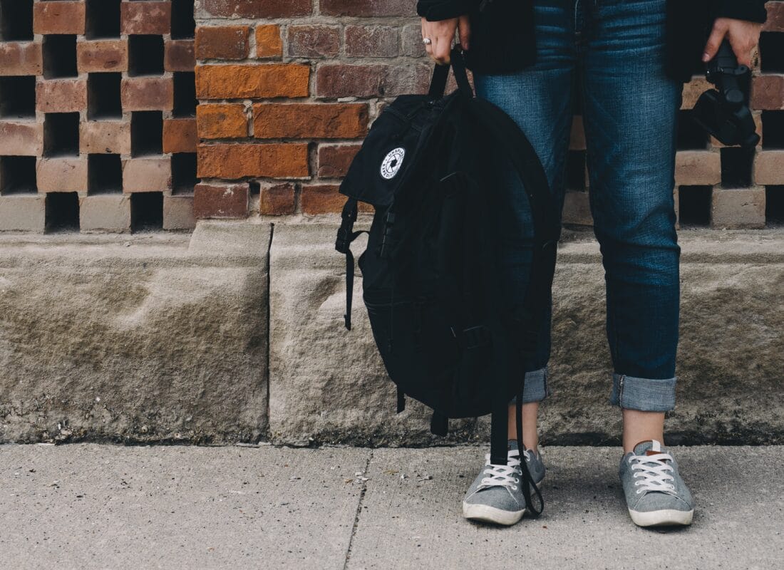 photo of teenager carrying a rucksack