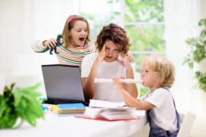 stressed mum trying to work at home with children