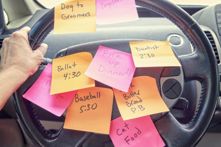 photo of steering wheel covered in reminder notes to illustrate article on 'Are you a parent stuck in work-mode?'