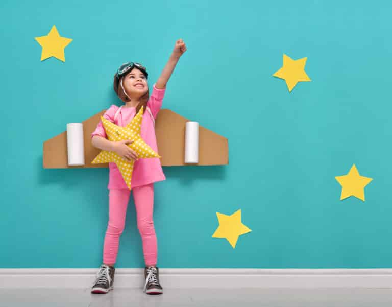 photo of a child playing with a box in article on play ideas for busy working parents by parenting expert Anita Cleare