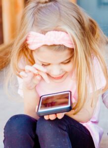 young child playing on a phone