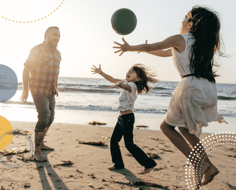 photo of happy family on a beach to illustrate parenting tips for a harmonious family holiday