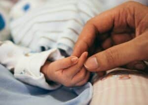 photo of baby's hand to illustrate article on role of touch in child development