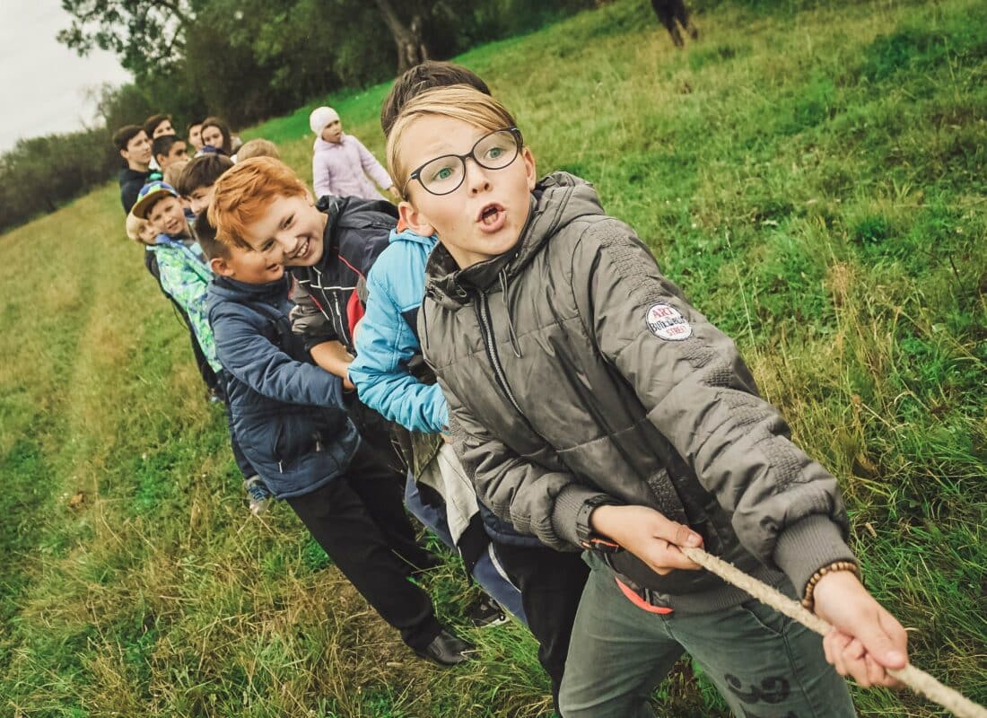 photo of children doing a tug-of-war with a rope