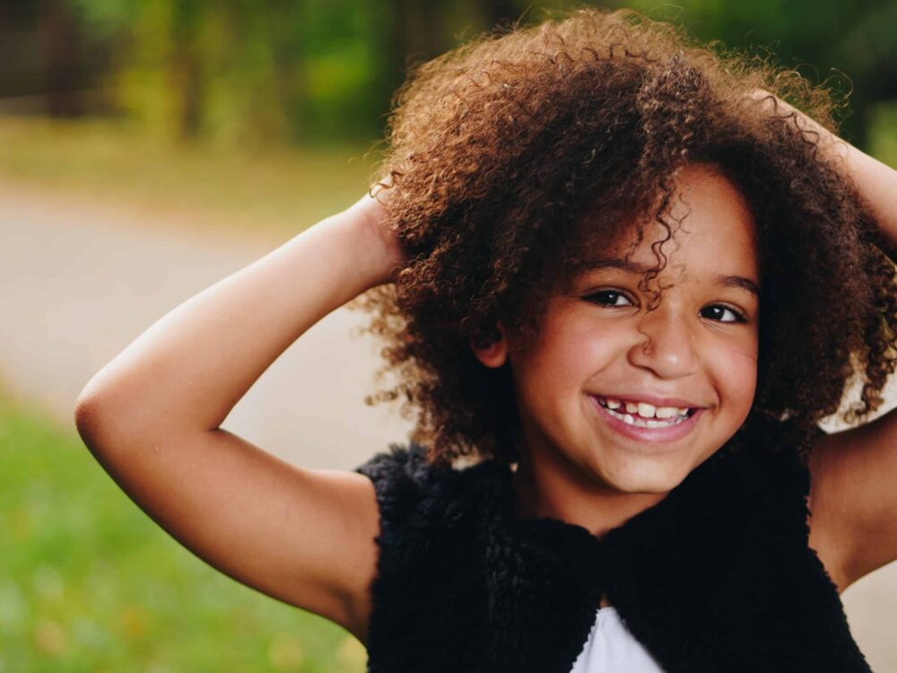 photo of happy young girl to illustarte parenting webinar titled "It's OK to Be Me"