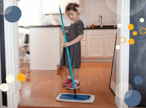 Photo of young girl mopping kitchen floor to illustrate article on the reasons children should do chores