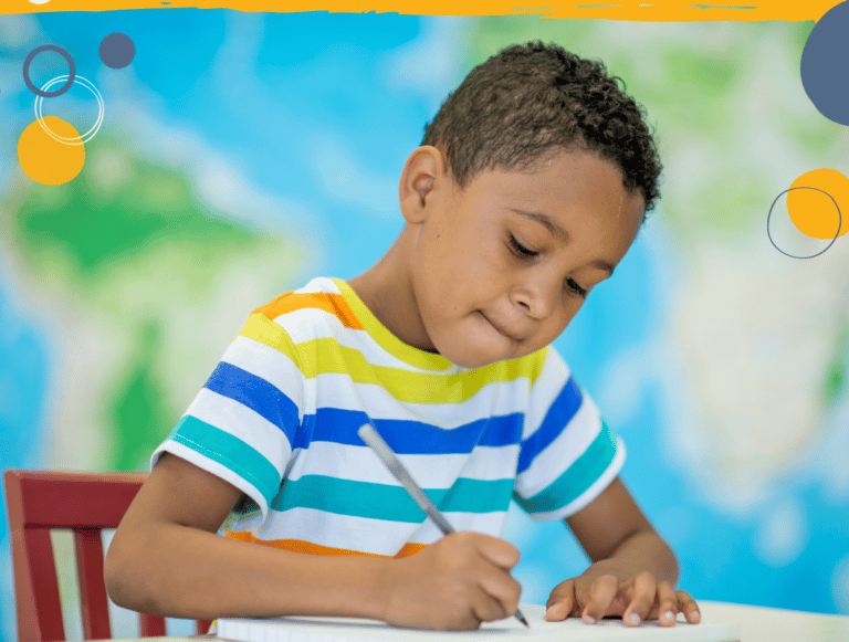 photo of young boy writing