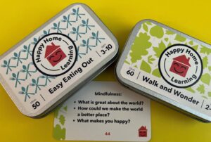 Photo of tins of prompt cards from Happy Home Learning UK