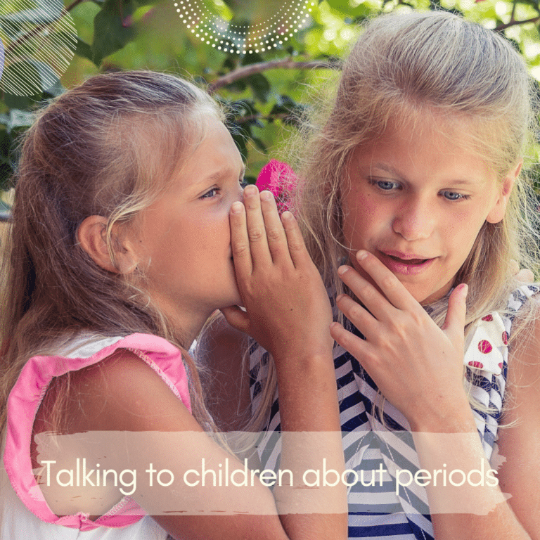 Photo of two young blond girls sharing a secret to each other behind their hands with banner reading "How to talk to children about periods"