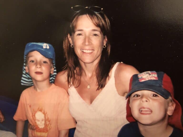 Old photo of Anita Cleare as a young mother seated with with her arms around a young boy on each side to illustrate article on how motherhood changes us and the many identity shifts mothers go through