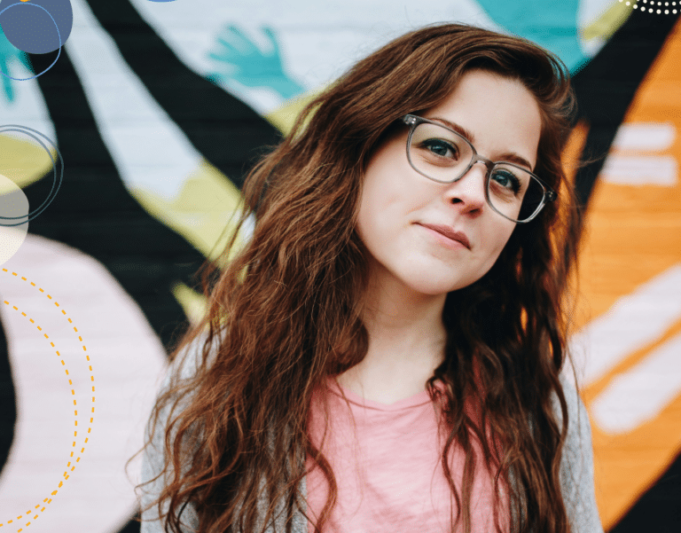 Photo of teenage girl standing against graffiti background to illustrate article by a teenage girl on how parents can help teens with school stress and grade anxiety