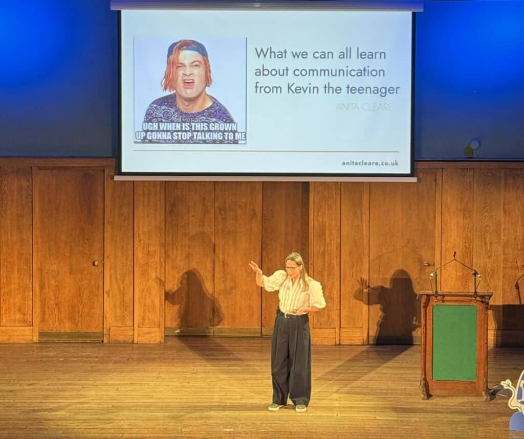 Parenting expert Anita Cleare on stage delivering a talk