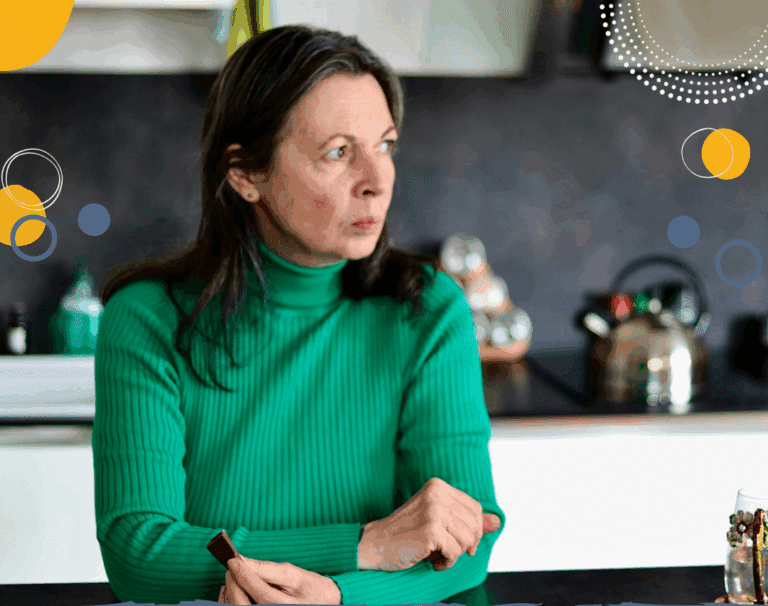 Photo of white woman with dark hair wearing a green jumper and looking very worried (to illustrate article discussing when parents worry too much)